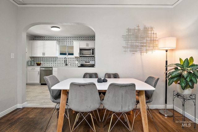 920 W Fort St, Boise, ID 83702 - dining area featuring arched walkways, baseboards, and dark wood finished floors