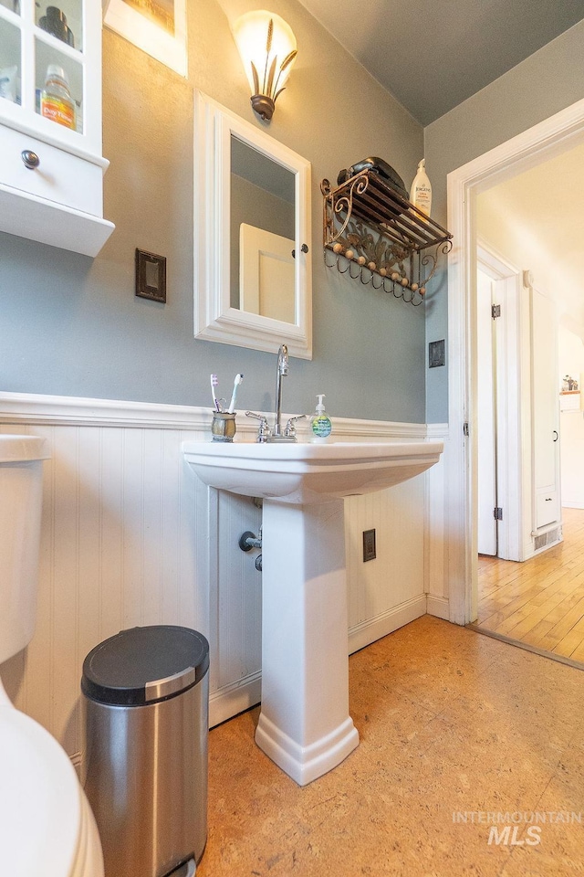702 S Opal St, Boise, ID 83705 - kitchen featuring a wainscoted wall and glass insert cabinets