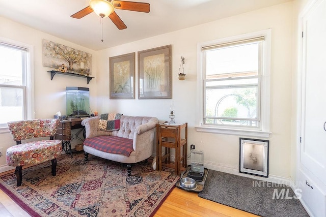 702 S Opal St, Boise, ID 83705 - living area with wood finished floors, a ceiling fan, and baseboards