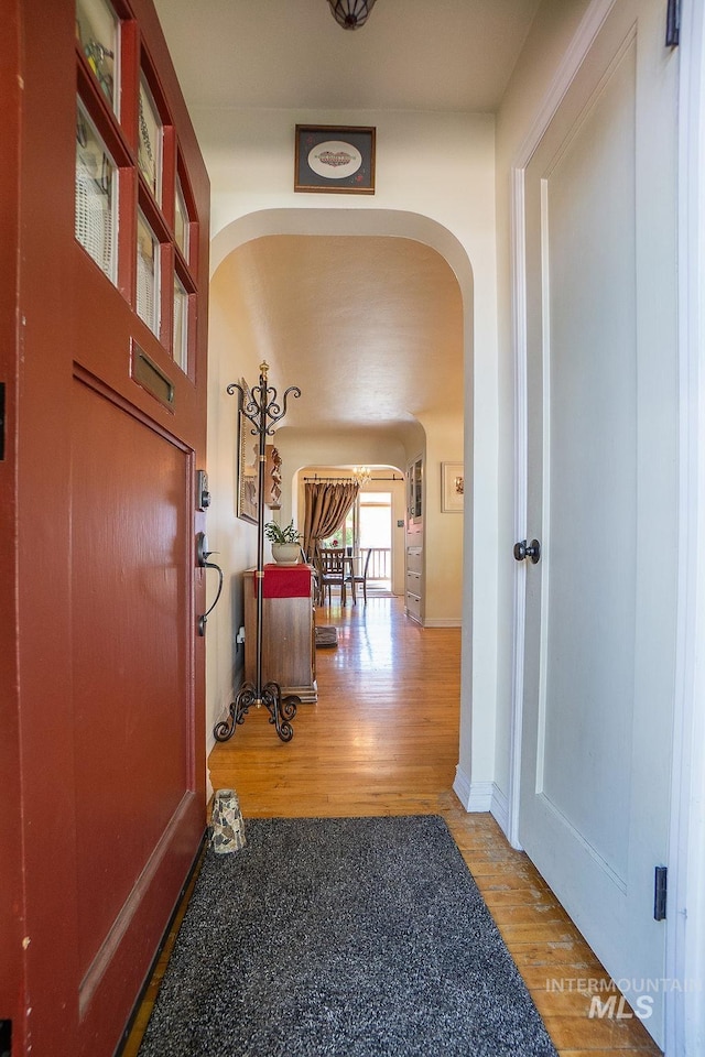 702 S Opal St, Boise, ID 83705 - hallway featuring arched walkways and wood finished floors