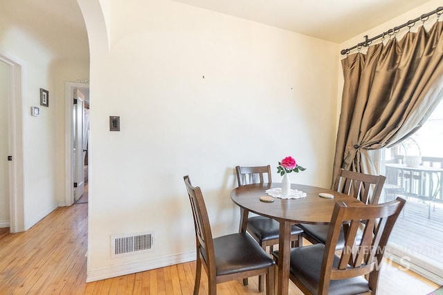 702 S Opal St, Boise, ID 83705 - dining space featuring arched walkways, light wood-style flooring, and baseboards