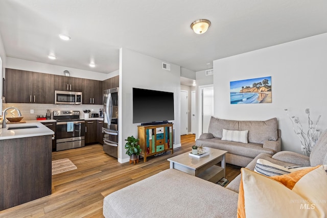 3480 N Prospect Ln, Garden City, ID 83714 - living room featuring visible vents and light wood-type flooring