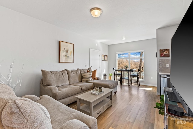 3480 N Prospect Ln, Garden City, ID 83714 - living room featuring baseboards and light wood-type flooring