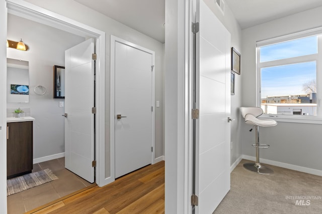 3480 N Prospect Ln, Garden City, ID 83714 - bathroom with baseboards, visible vents, wood finished floors, and vanity