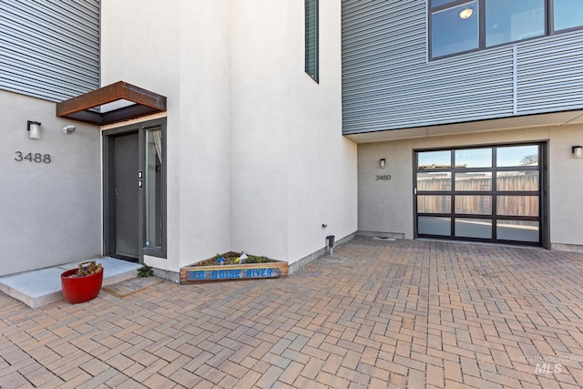 3480 N Prospect Ln, Garden City, ID 83714 - entrance to property featuring stucco siding and a patio