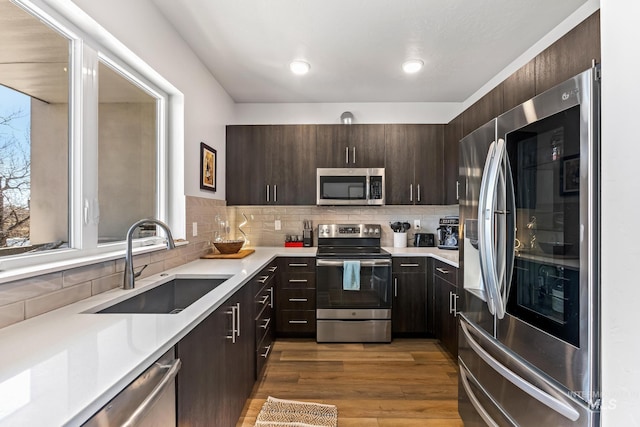 3480 N Prospect Ln, Garden City, ID 83714 - kitchen featuring a sink, light countertops, dark brown cabinetry, and appliances with stainless steel finishes