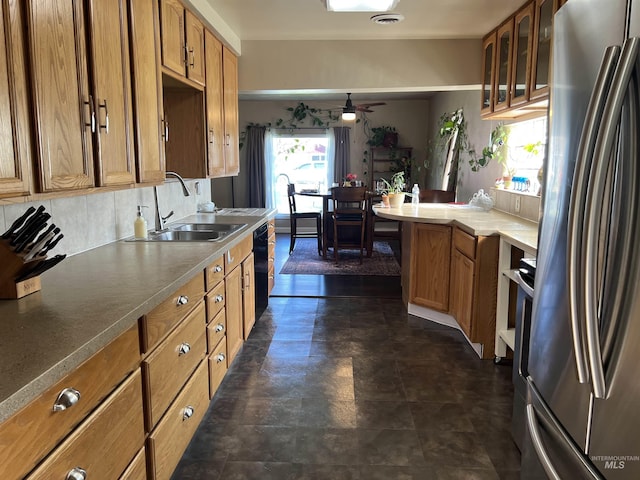 140 3rd St, Grand View, ID 83624 - kitchen featuring freestanding refrigerator, brown cabinetry, a ceiling fan, black dishwasher, and a sink