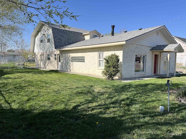140 3rd St, Grand View, ID 83624 - rear view of property with roof with shingles, a yard, stucco siding, and fence