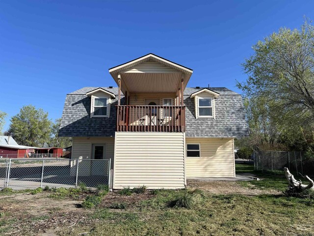 140 3rd St, Grand View, ID 83624 - back of property with roof with shingles, a gambrel roof, and fence