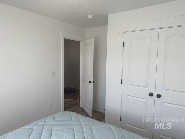 bedroom with a closet and wood finished floors