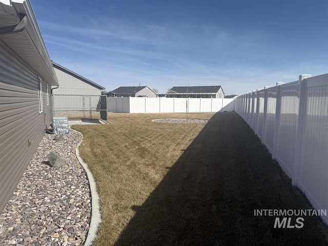 view of yard with a fenced backyard