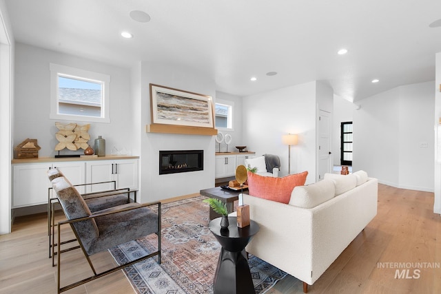 2365 E Valensole St, Meridian, ID 83642 - living area with a glass covered fireplace, recessed lighting, light wood finished floors, and baseboards