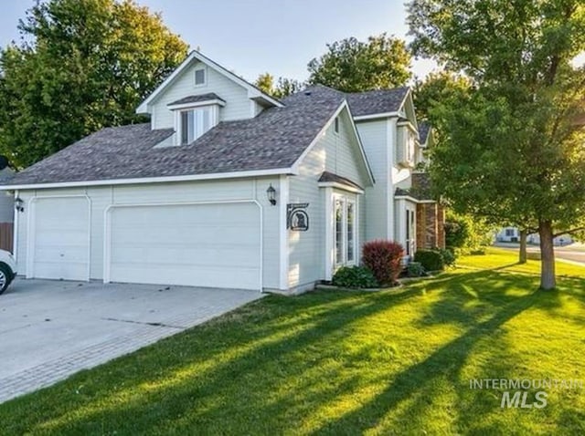 view of side of property with a yard and a garage