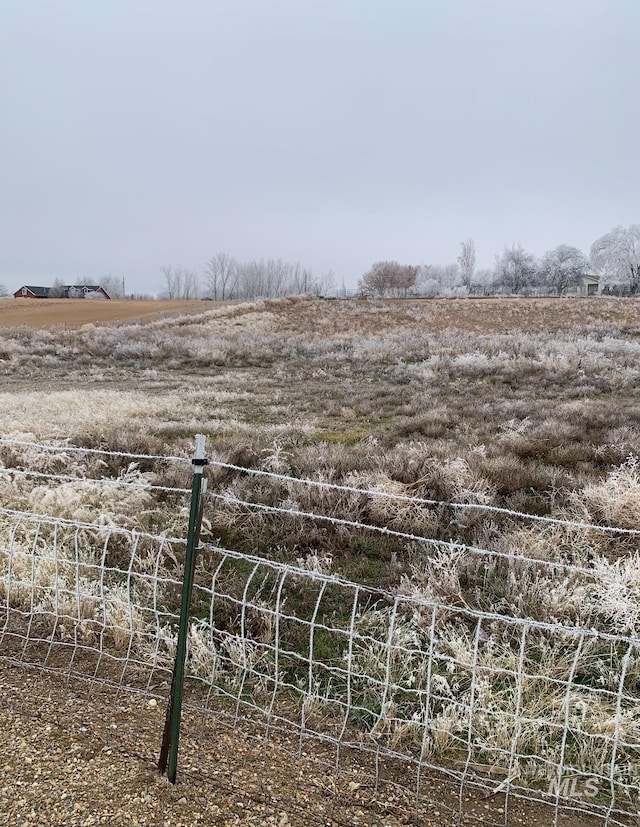 view of yard with a rural view