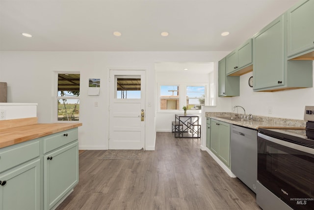 24722 Red Top Rd, Wilder, ID 83676 - kitchen with stainless steel appliances, green cabinetry, wood counters, and recessed lighting