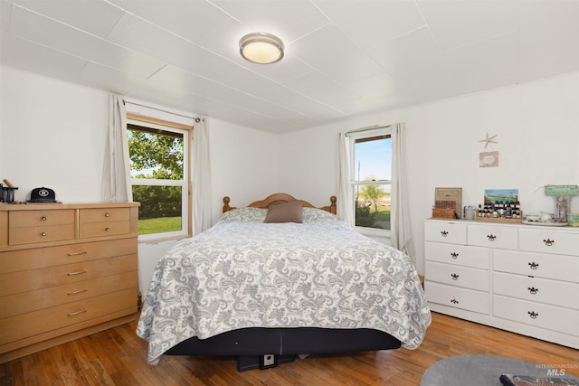 24722 Red Top Rd, Wilder, ID 83676 - bedroom featuring multiple windows and light wood finished floors