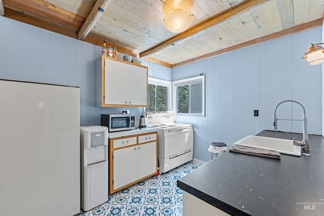 995 Cedar Crest Dr, Mccall, ID 83638 - kitchen featuring a sink, beam ceiling, stainless steel microwave, range, and wooden ceiling