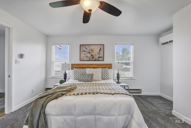 240 W Valley Rd, Hagerman, ID 83332 - bedroom with a baseboard heating unit, a wall mounted AC, baseboards, dark carpet, and ceiling fan