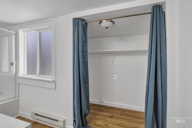 240 W Valley Rd, Hagerman, ID 83332 - bathroom with a baseboard heating unit, wood finished floors, curtained shower, and baseboards