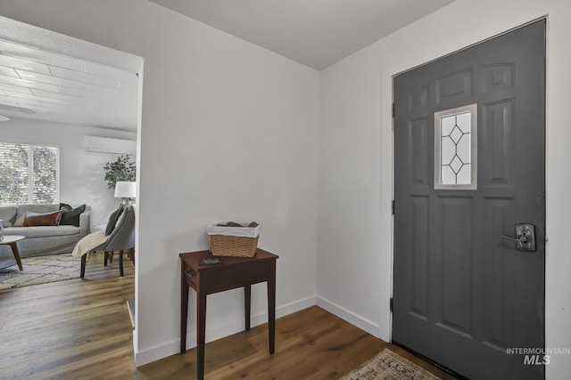240 W Valley Rd, Hagerman, ID 83332 - foyer entrance featuring dark wood-style flooring, baseboards, and a wall mounted AC