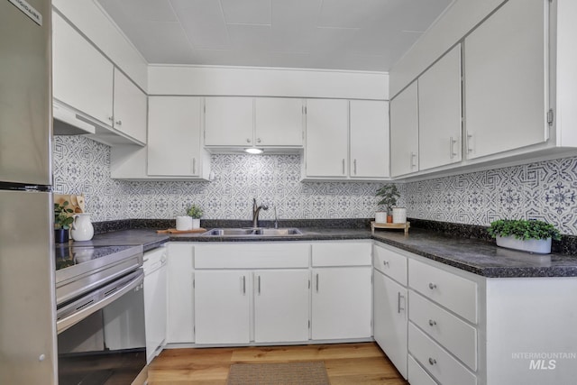 240 W Valley Rd, Hagerman, ID 83332 - kitchen with a sink, appliances with stainless steel finishes, white cabinets, dark countertops, and light wood finished floors