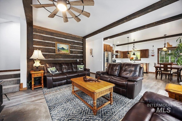 1010 N Hidden Pine Rd, Pine, ID 83647 - living area with a ceiling fan, wooden walls, light wood-style flooring, baseboards, and beam ceiling