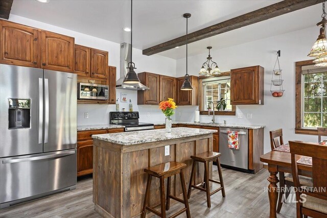 1010 N Hidden Pine Rd, Pine, ID 83647 - kitchen with appliances with stainless steel finishes, light wood-type flooring, wall chimney exhaust hood, beam ceiling, and a sink
