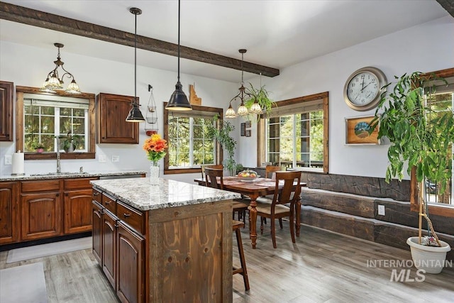 1010 N Hidden Pine Rd, Pine, ID 83647 - kitchen featuring a sink, beam ceiling, light wood-style flooring, a chandelier, and light stone countertops