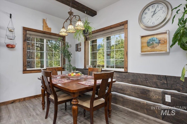 1010 N Hidden Pine Rd, Pine, ID 83647 - dining space with plenty of natural light, beam ceiling, wood finished floors, a chandelier, and baseboards