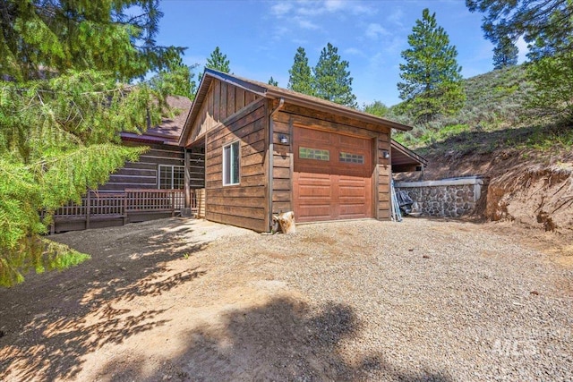 1010 N Hidden Pine Rd, Pine, ID 83647 - view of side of home with board and batten siding, dirt driveway, and a garage