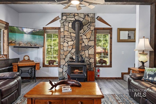 1010 N Hidden Pine Rd, Pine, ID 83647 - living area with a wood stove, a ceiling fan, baseboards, and wood finished floors