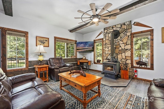 1010 N Hidden Pine Rd, Pine, ID 83647 - living area featuring a wood stove, a ceiling fan, wood finished floors, and baseboards