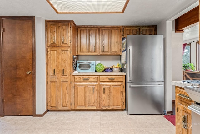 4 N 100 W, Fairfield, ID 83327 - kitchen featuring freestanding refrigerator, light countertops, and brown cabinetry