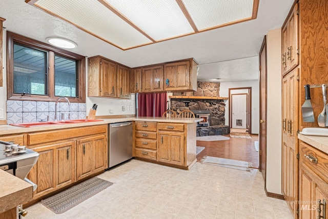 4 N 100 W, Fairfield, ID 83327 - kitchen featuring stainless steel dishwasher, a peninsula, light countertops, and brown cabinetry