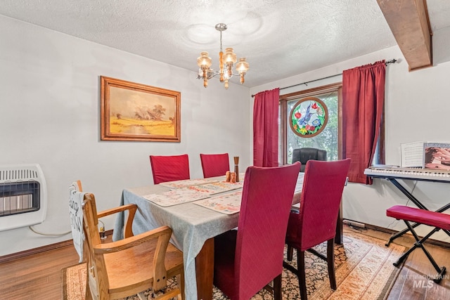 4 N 100 W, Fairfield, ID 83327 - dining room with heating unit, wood finished floors, a chandelier, and a textured ceiling