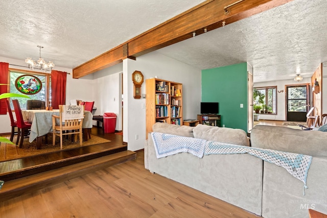 4 N 100 W, Fairfield, ID 83327 - living area with a chandelier, a textured ceiling, wood finished floors, and beamed ceiling