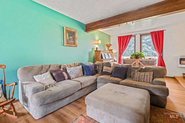 4 N 100 W, Fairfield, ID 83327 - living room featuring a textured ceiling, beam ceiling, wood finished floors, and heating unit