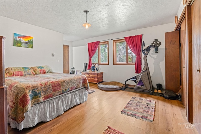 4 N 100 W, Fairfield, ID 83327 - bedroom with hardwood / wood-style flooring and a textured ceiling