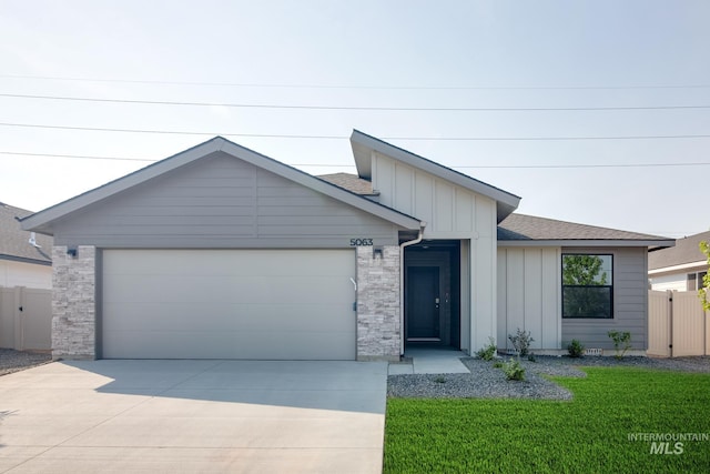 view of front facade with a garage and a front lawn