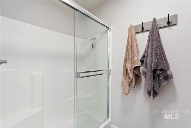 bathroom with a shower with door