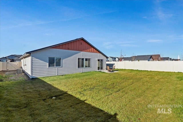 rear view of house with a lawn