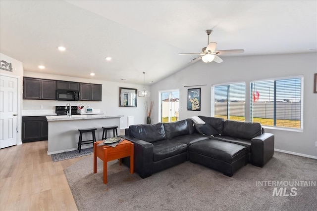 living room with light hardwood / wood-style flooring, ceiling fan, lofted ceiling, and sink