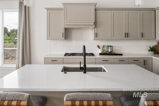 2005 W Freya Ct, Eagle, ID 83616 - kitchen with gray cabinets, a sink, light countertops, and backsplash