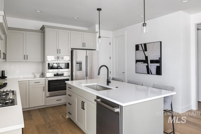 2005 W Freya Ct, Eagle, ID 83616 - kitchen with a sink, appliances with stainless steel finishes, wood finished floors, light countertops, and recessed lighting