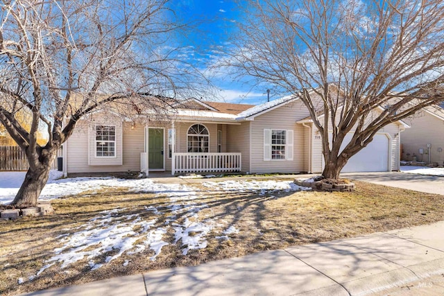 ranch-style house with a garage and covered porch