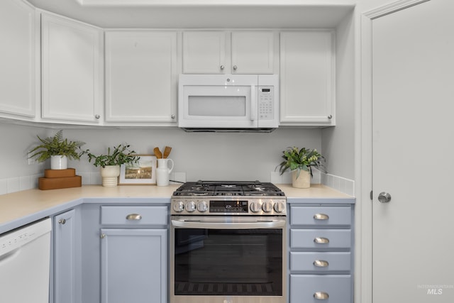 kitchen featuring white cabinets and white appliances