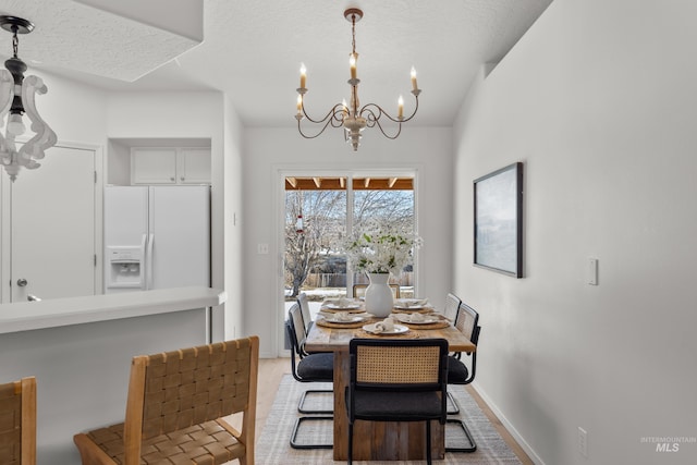 dining room featuring a notable chandelier and a textured ceiling