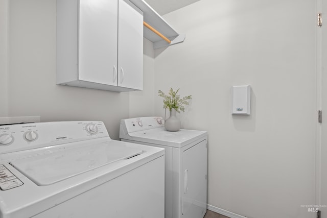 laundry room with cabinets and separate washer and dryer