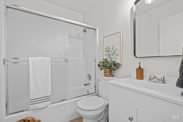 full bathroom featuring enclosed tub / shower combo, vanity, and toilet