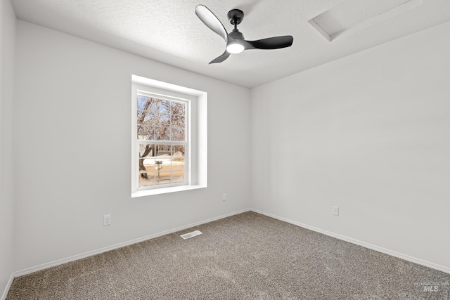 unfurnished room with ceiling fan, a textured ceiling, and carpet flooring